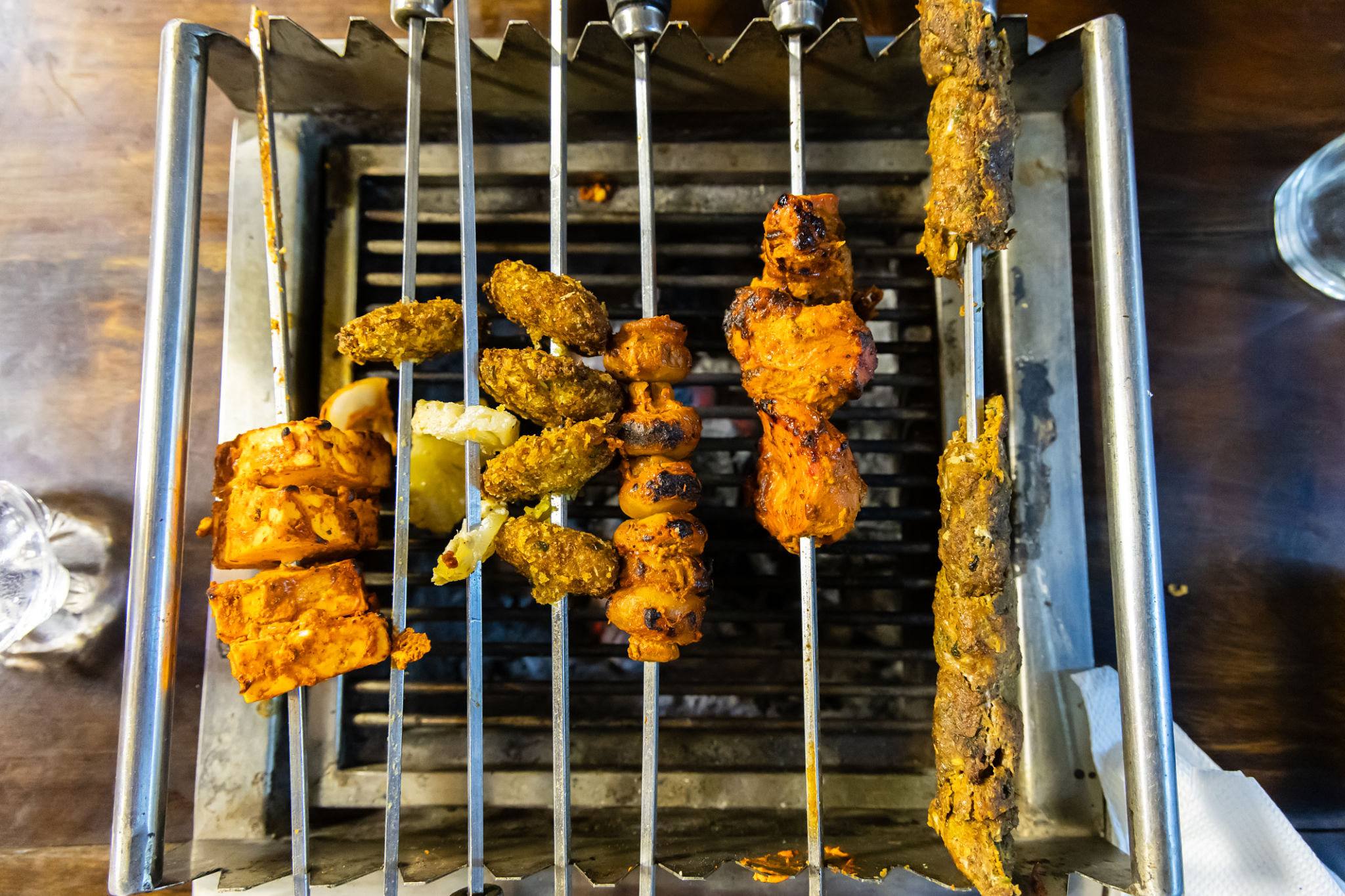 Tandoori and seekh kebabs grilling over hot coals